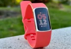 Fitbit Charge 6 fitness tracker on wrist showing health stats