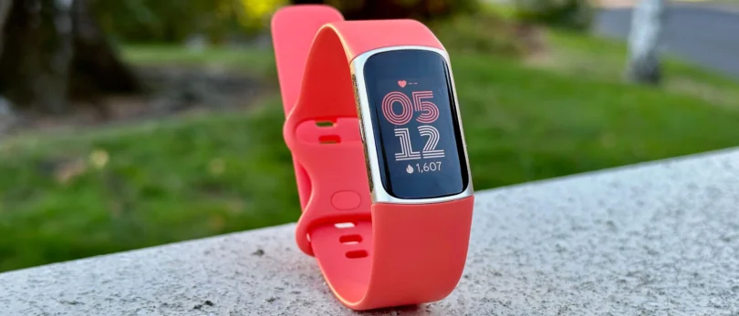 Fitbit Charge 6 fitness tracker on wrist showing health stats